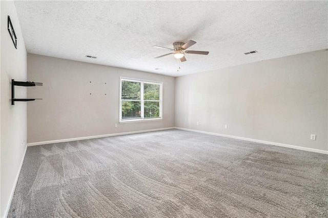 unfurnished room with ceiling fan, a textured ceiling, and carpet floors