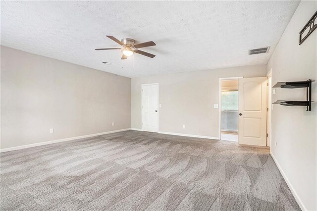 unfurnished bedroom with ceiling fan, carpet, and a textured ceiling