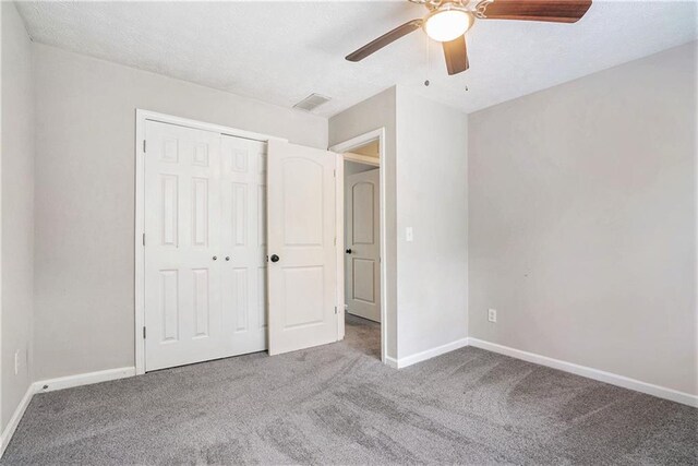 unfurnished bedroom with a closet, ceiling fan, and carpet floors