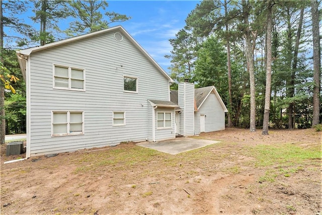 rear view of house featuring a patio area and central air condition unit