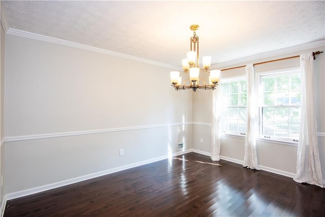 unfurnished room with a textured ceiling, a chandelier, crown molding, and dark hardwood / wood-style floors