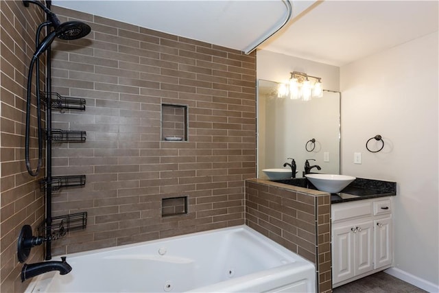 bathroom featuring vanity and tiled shower / bath