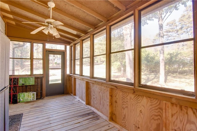 unfurnished sunroom featuring ceiling fan and lofted ceiling with beams