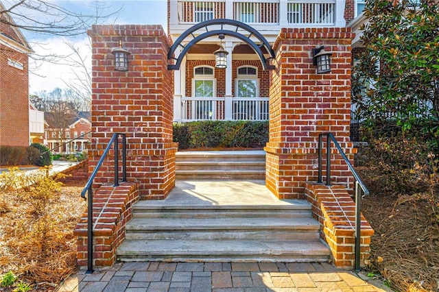 view of exterior entry featuring brick siding