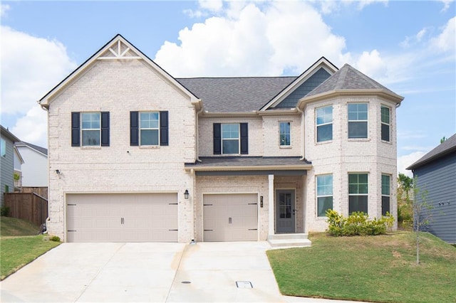 view of front of home featuring a garage and a front lawn