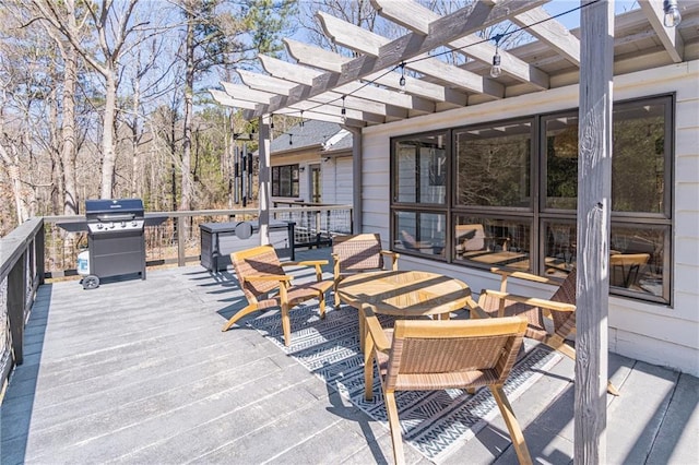 wooden deck with a grill and a pergola