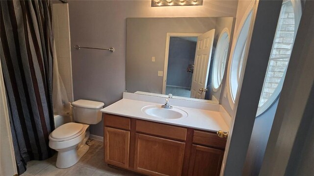 full bathroom with tile patterned flooring, vanity, shower / bathtub combination with curtain, and toilet