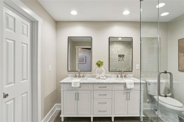 645 Trailmore Pl, Roswell, GA 30076 - bathroom with baseboards, double vanity, a sink, and toilet
