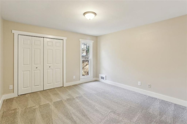645 Trailmore Pl, Roswell, GA 30076 - unfurnished bedroom with baseboards, visible vents, a closet, and carpet