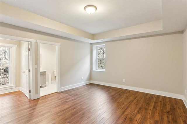645 Trailmore Pl, Roswell, GA 30076 - empty room with baseboards, wood finished floors, and a raised ceiling