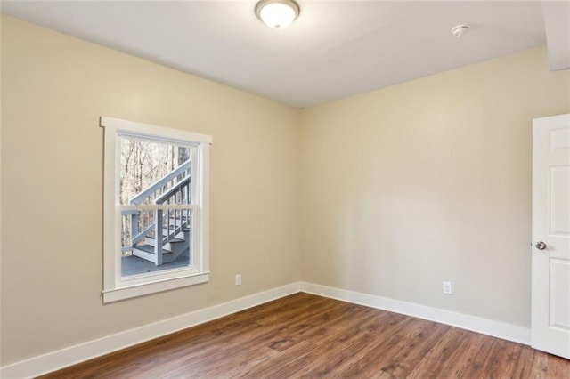 645 Trailmore Pl, Roswell, GA 30076 - spare room featuring baseboards and dark wood-type flooring