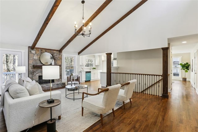 645 Trailmore Pl, Roswell, GA 30076 - living area featuring decorative columns, a chandelier, beam ceiling, a stone fireplace, and wood finished floors