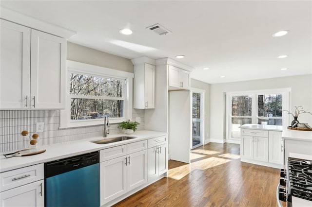 645 Trailmore Pl, Roswell, GA 30076 - kitchen featuring dishwashing machine, visible vents, wood finished floors, and a sink