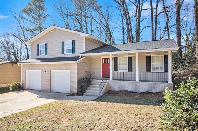 split level home featuring a front yard and a garage