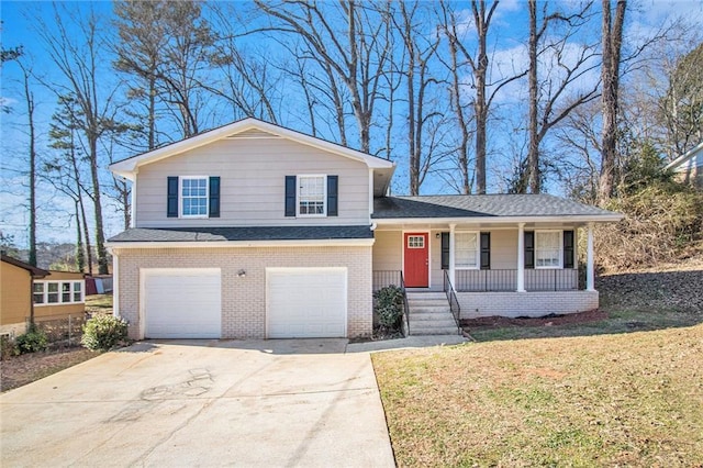 split level home with a front yard, a porch, and a garage