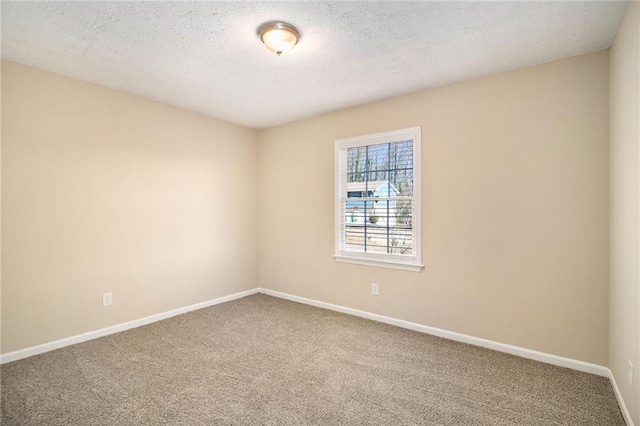 unfurnished room with carpet flooring and a textured ceiling