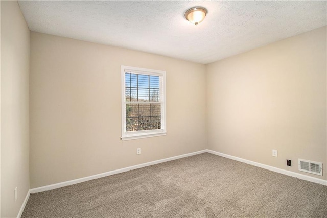 unfurnished room featuring carpet floors and a textured ceiling