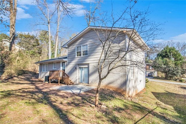 rear view of property featuring a lawn