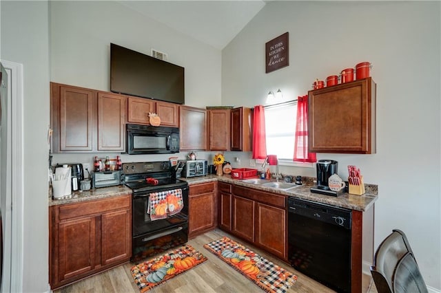 504 Cole Creek Dr, Dallas, GA 30157 - kitchen featuring black appliances, a sink, light wood-style flooring, high vaulted ceiling, and brown cabinets