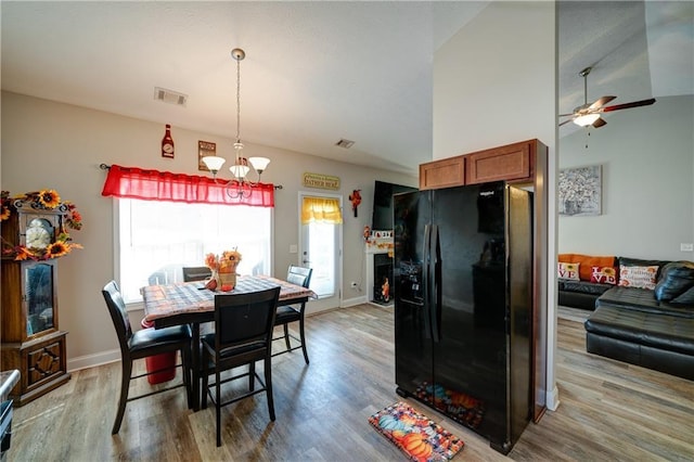 504 Cole Creek Dr, Dallas, GA 30157 - dining space featuring a chandelier, light wood-style floors, ceiling fan, vaulted ceiling, and baseboards