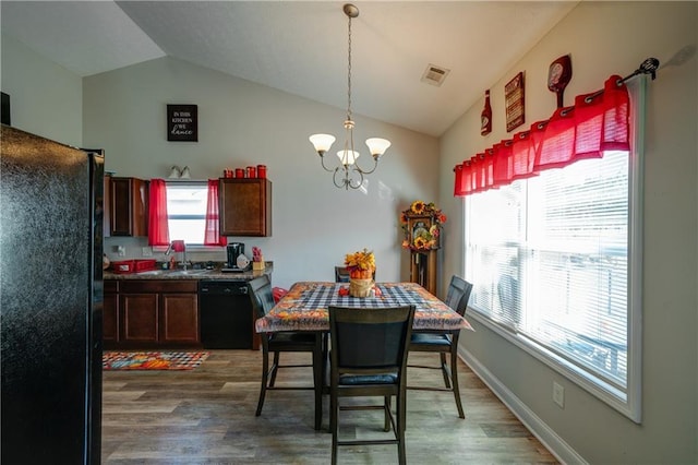 504 Cole Creek Dr, Dallas, GA 30157 - dining room featuring vaulted ceiling, a chandelier, and wood finished floors