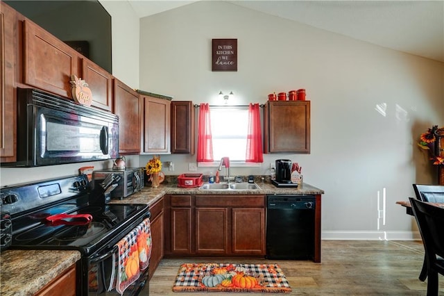 504 Cole Creek Dr, Dallas, GA 30157 - kitchen with black appliances, a sink, light wood finished floors, baseboards, and high vaulted ceiling