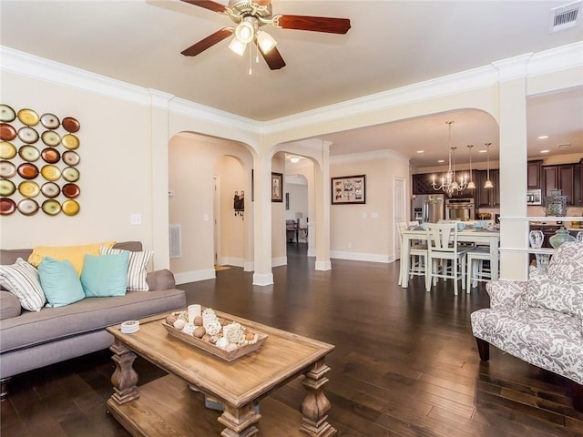 living room featuring hardwood / wood-style flooring, crown molding, and ceiling fan with notable chandelier