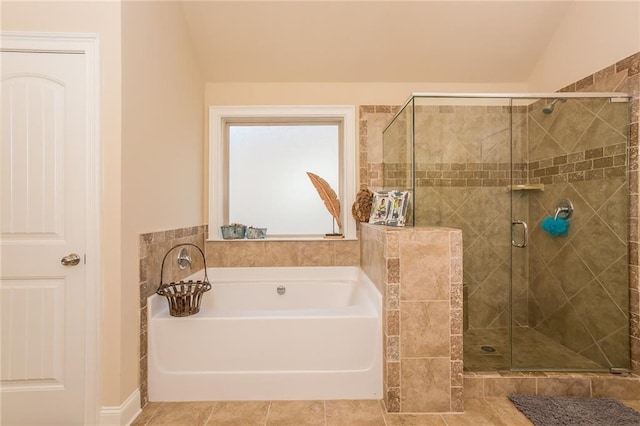 bathroom with shower with separate bathtub, tile patterned floors, and lofted ceiling