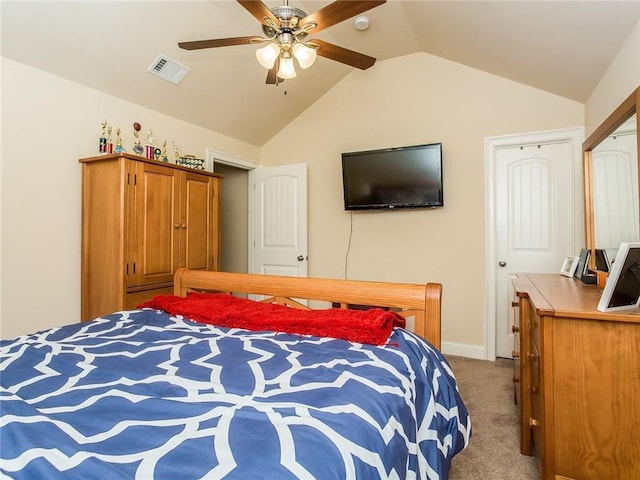 carpeted bedroom with ceiling fan, a closet, and vaulted ceiling