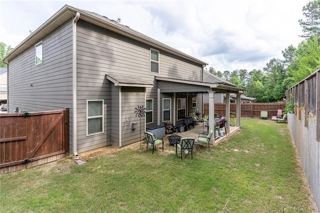 back of property featuring a patio area and a yard