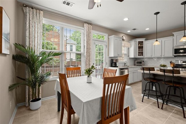2303 Waters Edge Trl, Roswell, GA 30075 - dining room featuring plenty of natural light, light tile patterned floors, a ceiling fan, baseboards, and recessed lighting