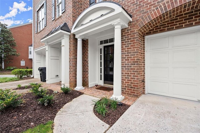 2303 Waters Edge Trl, Roswell, GA 30075 - view of exterior entry with brick siding, driveway, and an attached garage