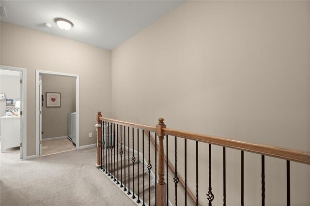 2303 Waters Edge Trl, Roswell, GA 30075 - hall with an upstairs landing, light carpet, baseboards, and washer / dryer