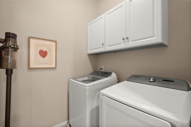 2303 Waters Edge Trl, Roswell, GA 30075 - clothes washing area with cabinet space, washing machine and clothes dryer, and baseboards