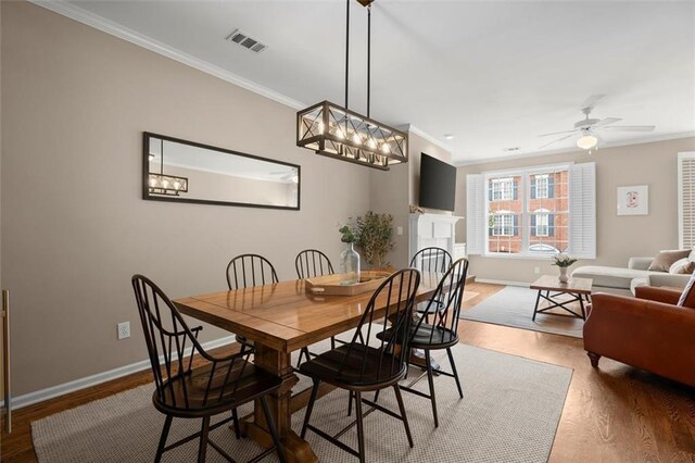 2303 Waters Edge Trl, Roswell, GA 30075 - dining area featuring crown molding, wood finished floors, baseboards, and ceiling fan