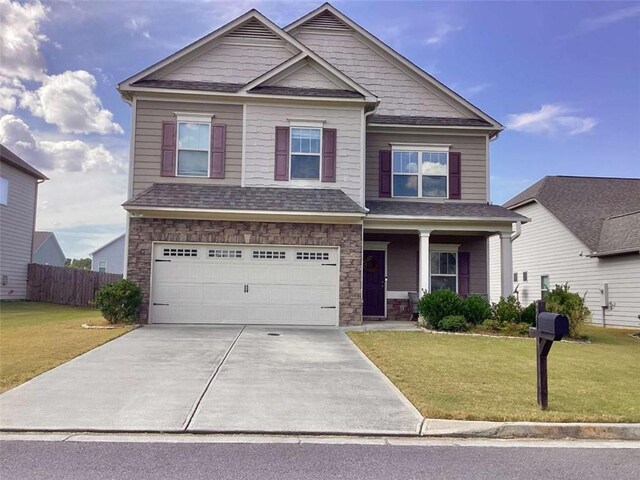 craftsman-style home with a front lawn and a garage