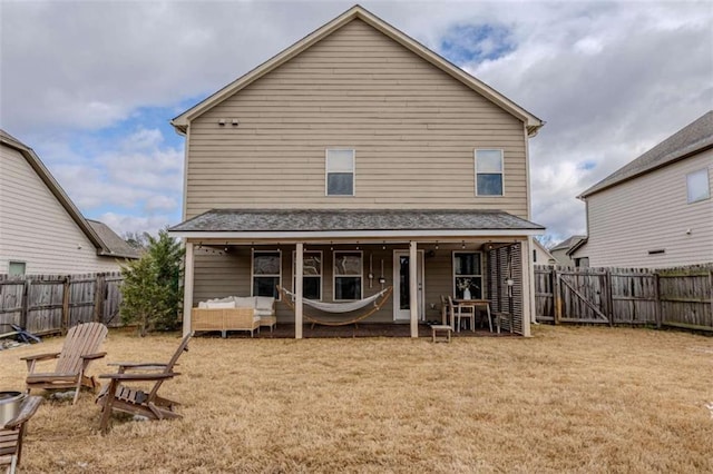 back of house with a lawn