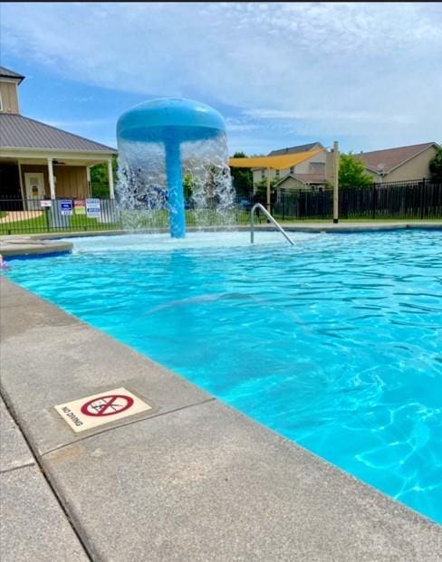 view of swimming pool featuring pool water feature