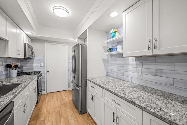 kitchen featuring white cabinets, stainless steel appliances, and light hardwood / wood-style floors