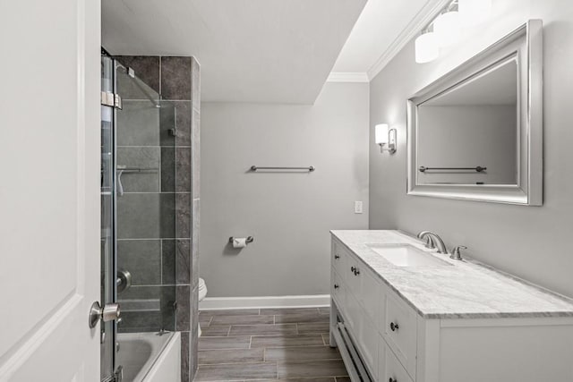 full bathroom featuring vanity, toilet, ornamental molding, and tiled shower / bath combo