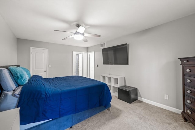 bedroom with ceiling fan and light carpet