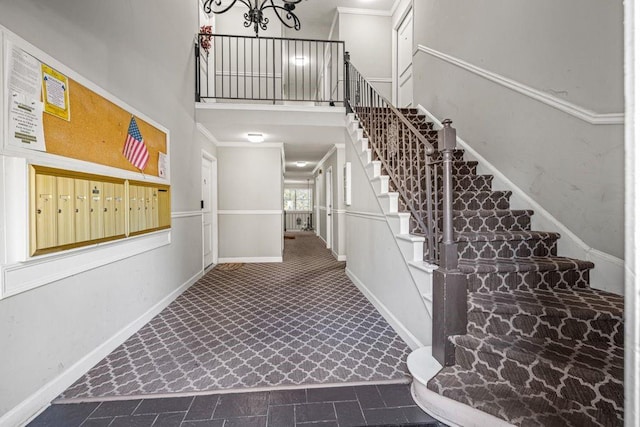 stairway featuring crown molding and a mail area