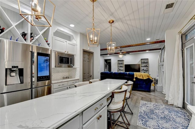 127 Bradshaw Park Dr, Woodstock, GA 30188 - kitchen featuring appliances with stainless steel finishes, a chandelier, wood ceiling, decorative backsplash, and white cabinets