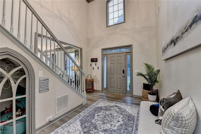 127 Bradshaw Park Dr, Woodstock, GA 30188 - foyer entrance featuring wood finished floors, a high ceiling, stairs, and arched walkways