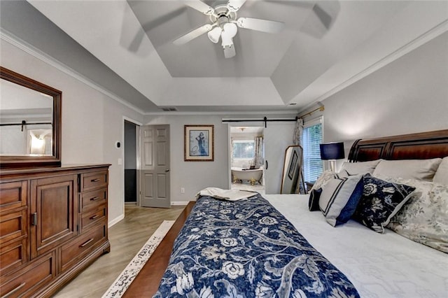 127 Bradshaw Park Dr, Woodstock, GA 30188 - bedroom with a tray ceiling, light wood-style flooring, ensuite bath, and ceiling fan