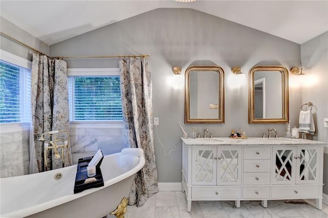 127 Bradshaw Park Dr, Woodstock, GA 30188 - bathroom with vaulted ceiling, marble look tiles, a soaking tub, and double vanity