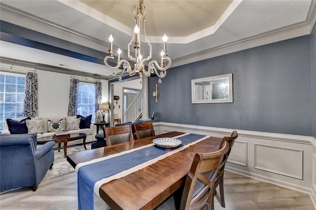 127 Bradshaw Park Dr, Woodstock, GA 30188 - dining room with a chandelier, a raised ceiling, wood finished floors, a wainscoted wall, and ornamental molding