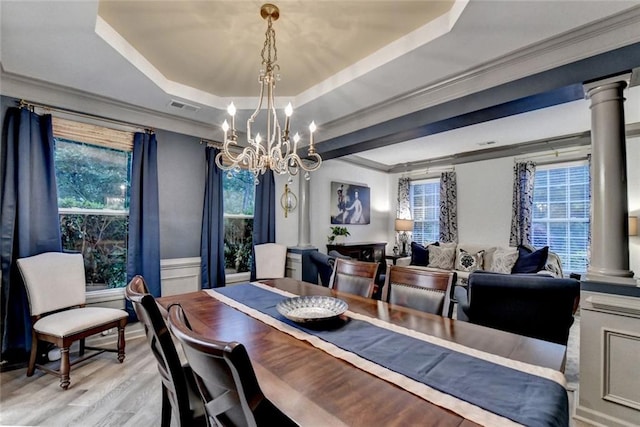 127 Bradshaw Park Dr, Woodstock, GA 30188 - dining room with a tray ceiling, decorative columns, a chandelier, crown molding, and plenty of natural light