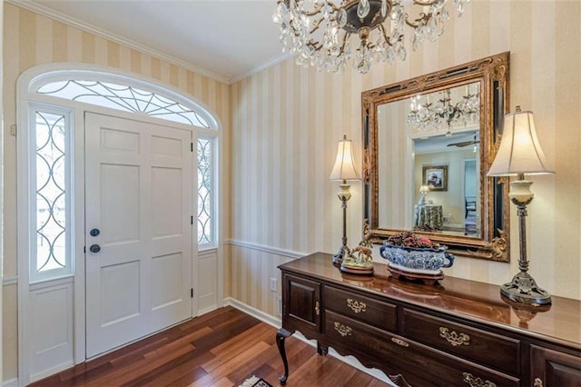 entryway with wallpapered walls, ornamental molding, dark wood-style flooring, and a wainscoted wall