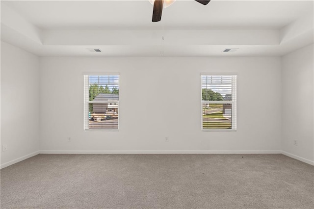 spare room with carpet flooring, a ceiling fan, and plenty of natural light